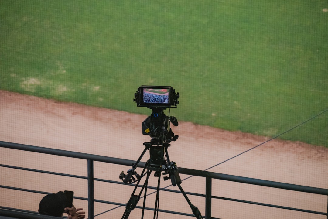 A camera on a tripod at a baseball game